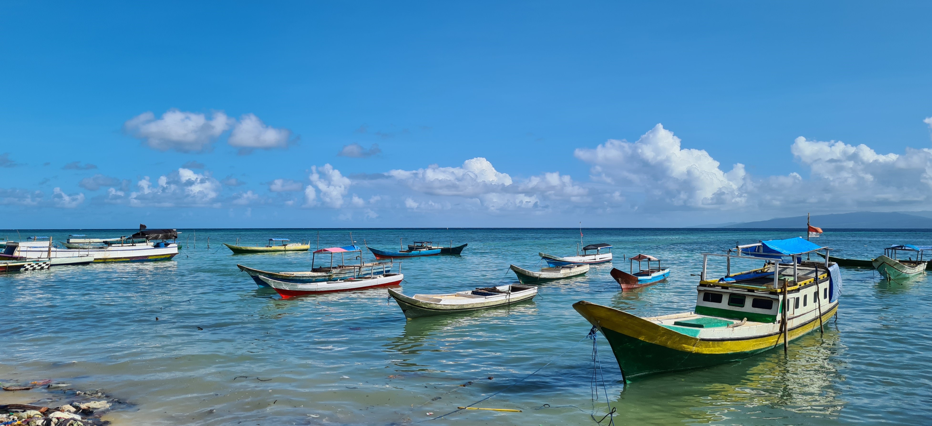 Vessels sitting on the water near shore